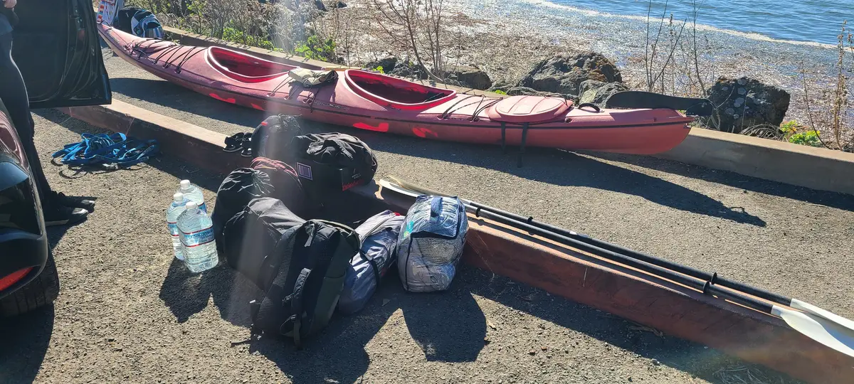 Red kayaks and gear at the launch point