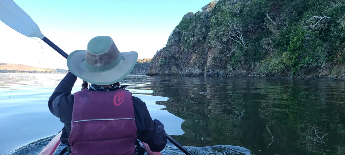 Paddling past a rocky headland on the west shore