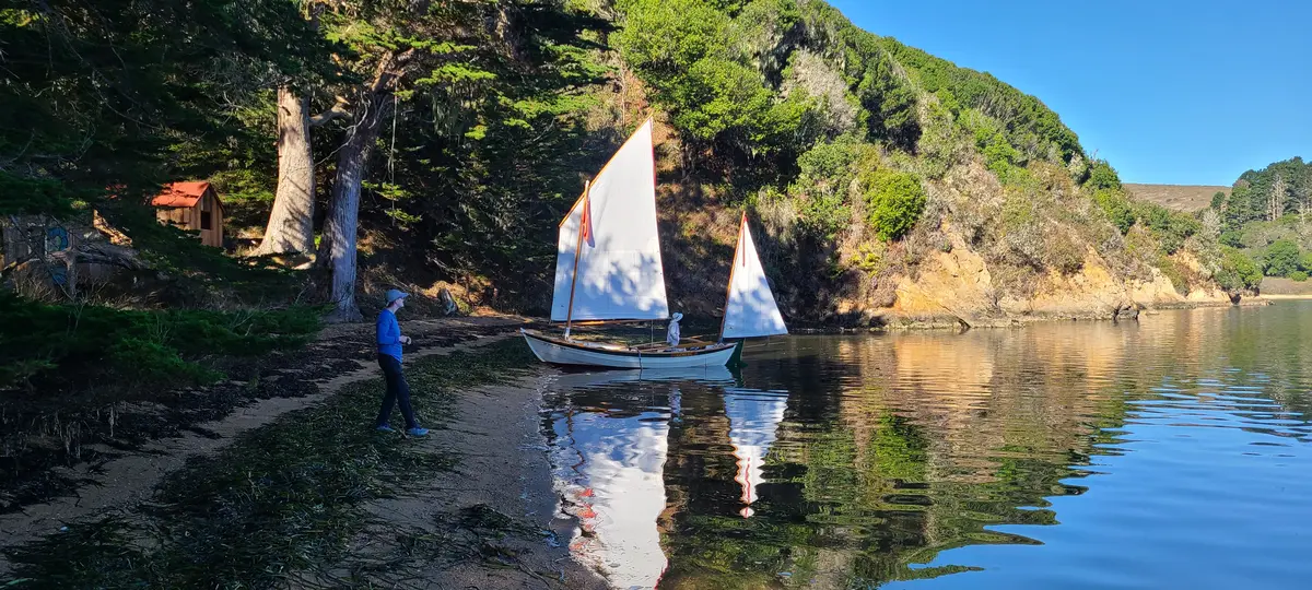 A TSCA sailboat launching from the cove